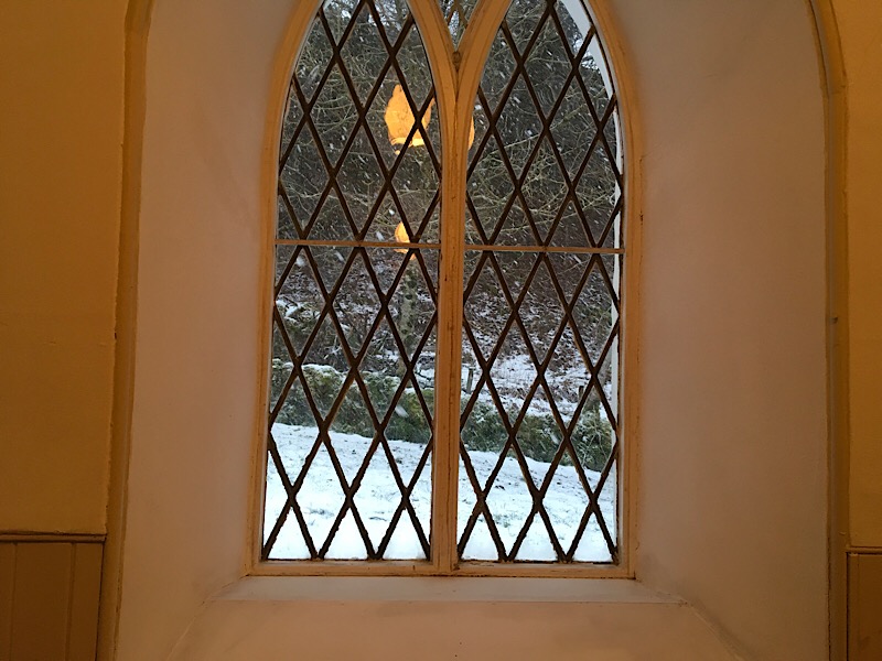 Snow falling seen through the window